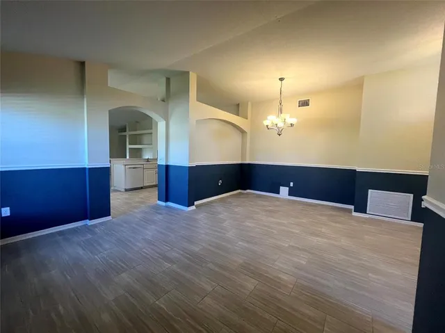 a view of a kitchen with a sink and a chandelier