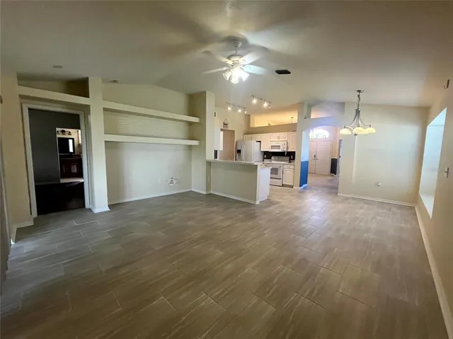 a view of a kitchen with a sink and a refrigerator