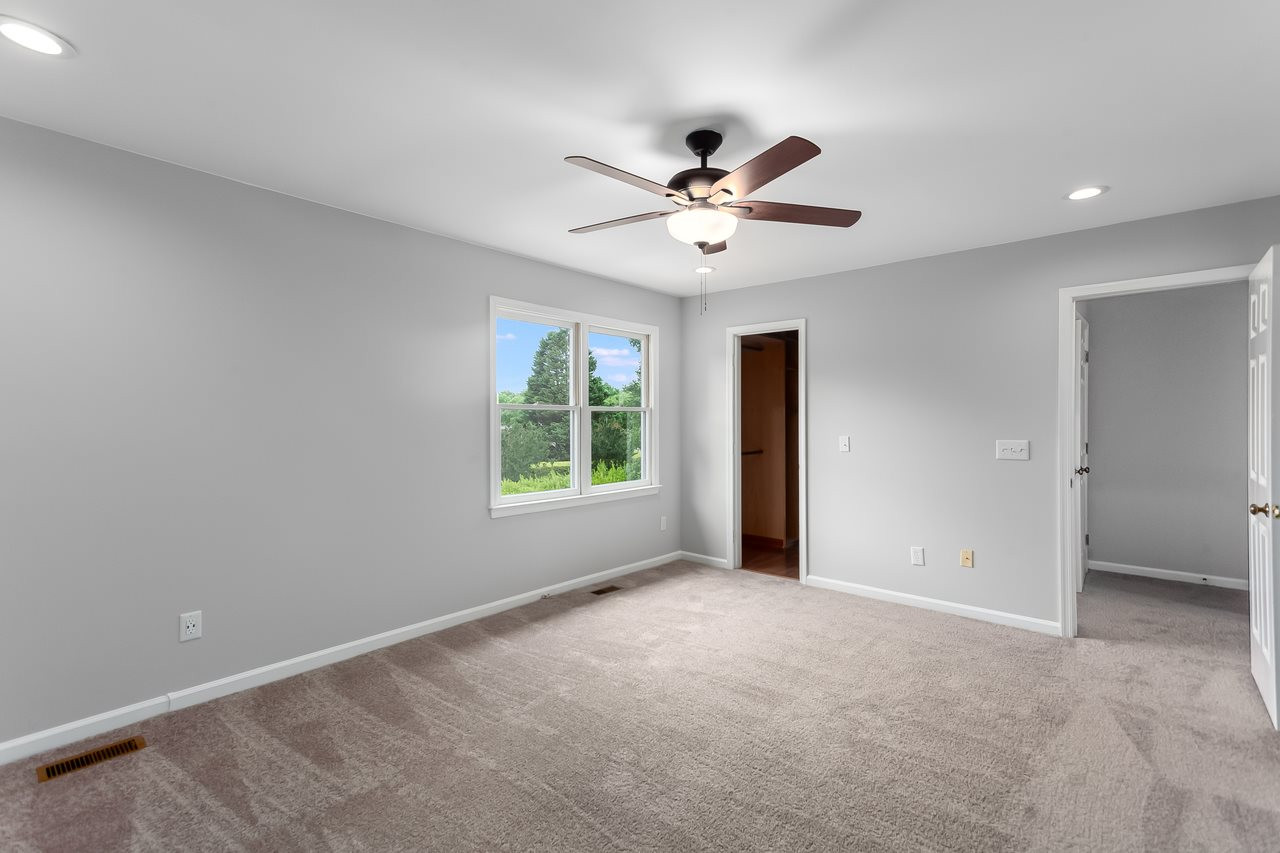 6903 Saxby Court Raleigh, NC 27613 - Photo 8 of 11 Hard to see in this photo, but the master has a custom walk-on closet like no other! Master Bedroom