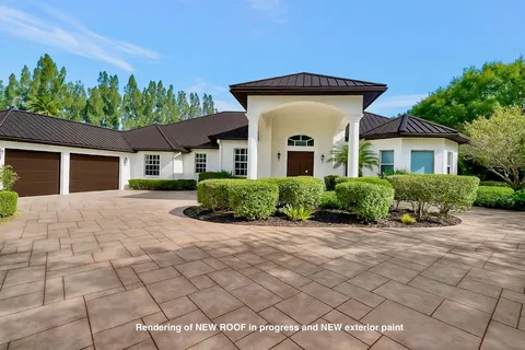 an aerial view of a house with a yard and outdoor seating