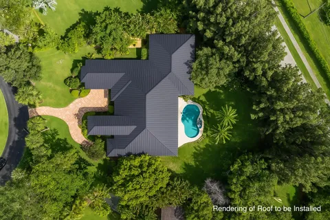 an aerial view of a house with a yard and garden