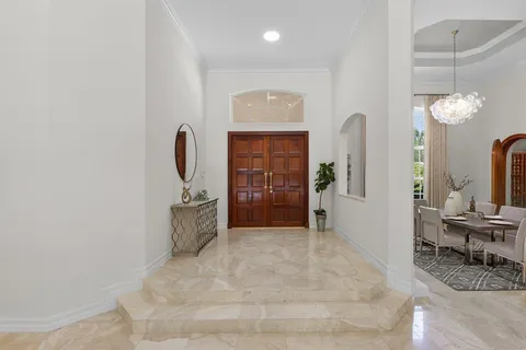 a view of a dining room with furniture and chandelier
