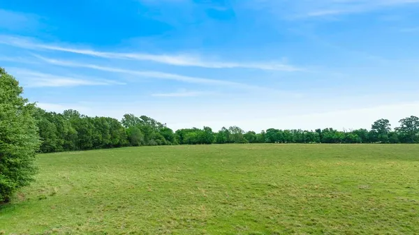 a view of a lake view with a trees in the background