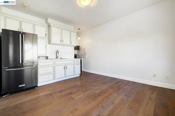a kitchen with granite countertop stainless steel appliances white cabinets granite counter tops and a window