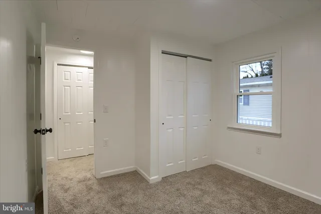 a view of an empty room and closet area