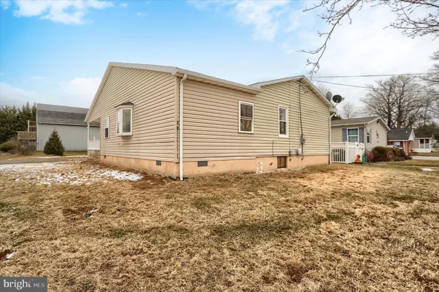 a view of a house with a yard and sitting area