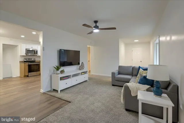 an empty room with a ceiling fan and a window