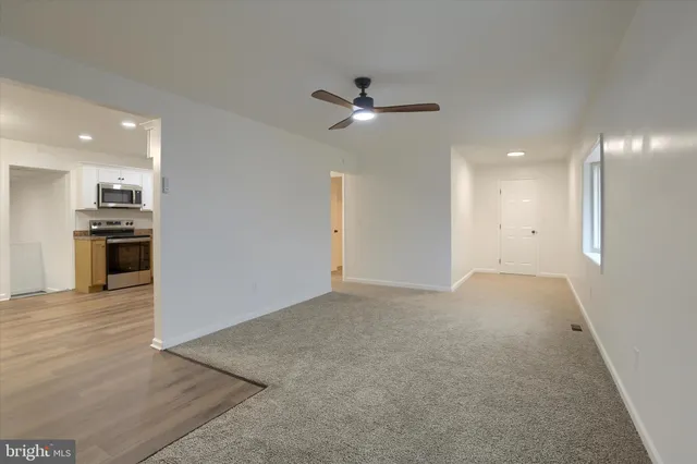 a kitchen with granite countertop white cabinets and stainless steel appliances