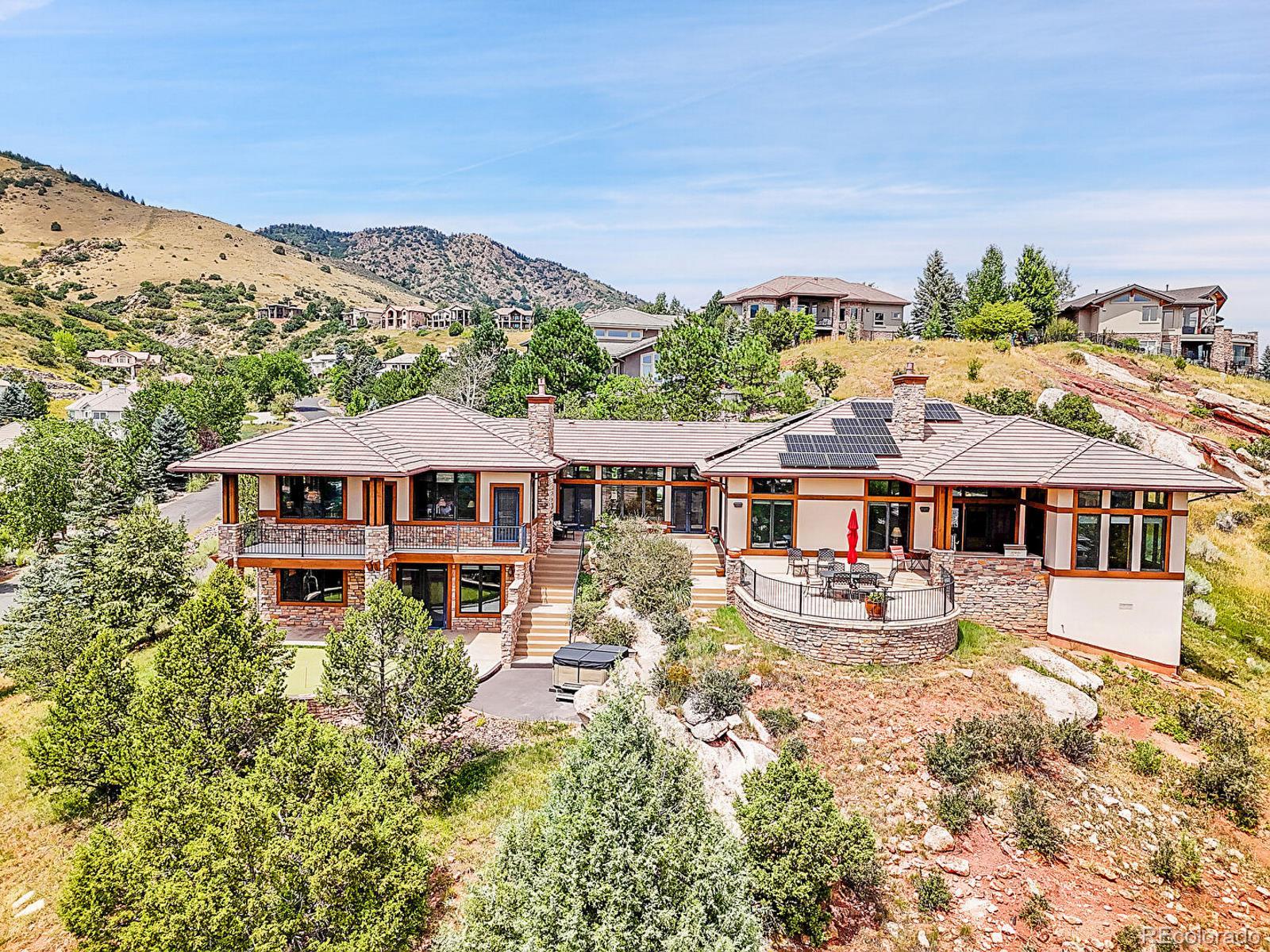 an aerial view of a house with a yard and sitting area