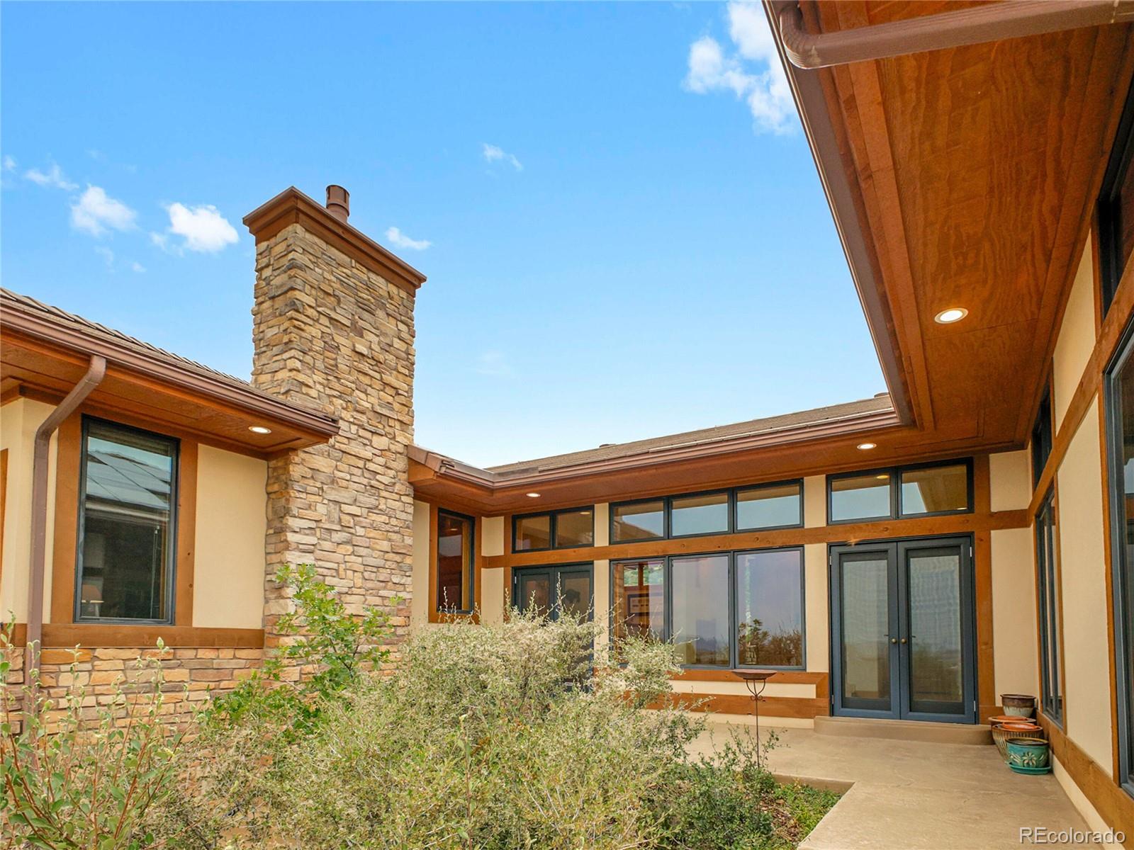 16285 Sandstone Drive Morrison, CO 80465 - Photo 16 of 47 a front view of a house with a yard