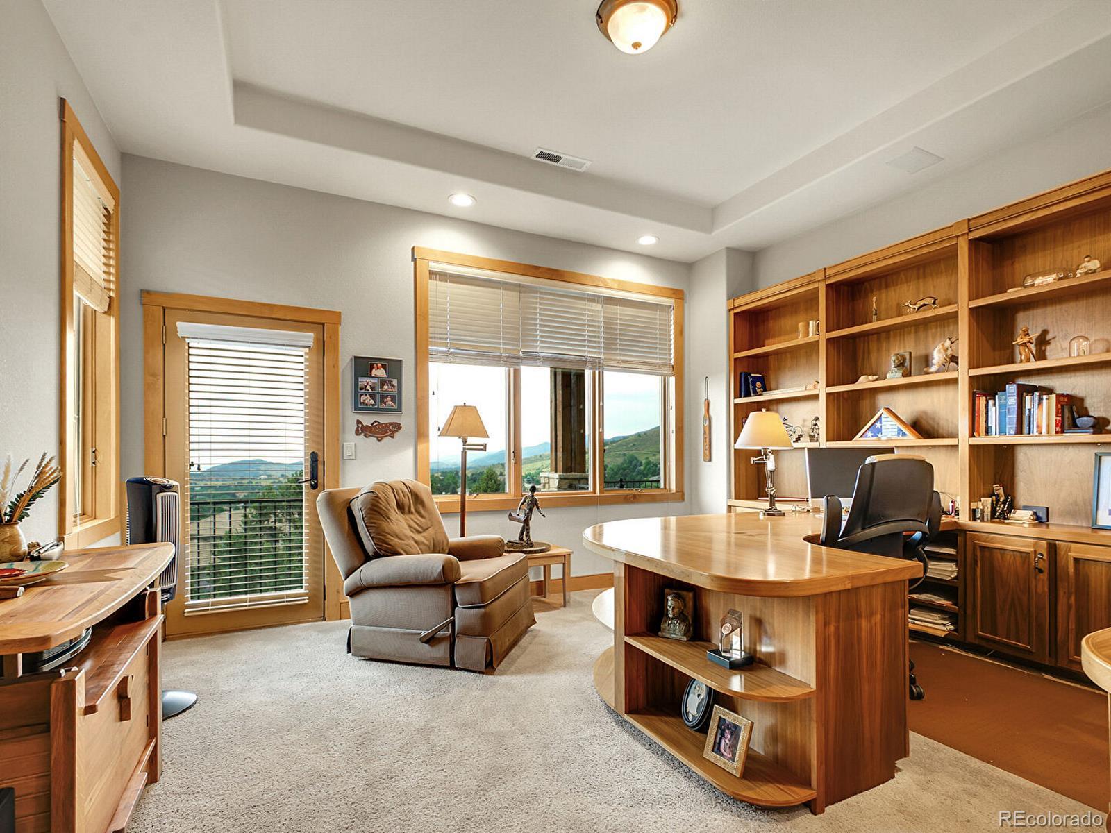 16285 Sandstone Drive Morrison, CO 80465 - Photo 19 of 47 a living room with furniture and a flat screen tv