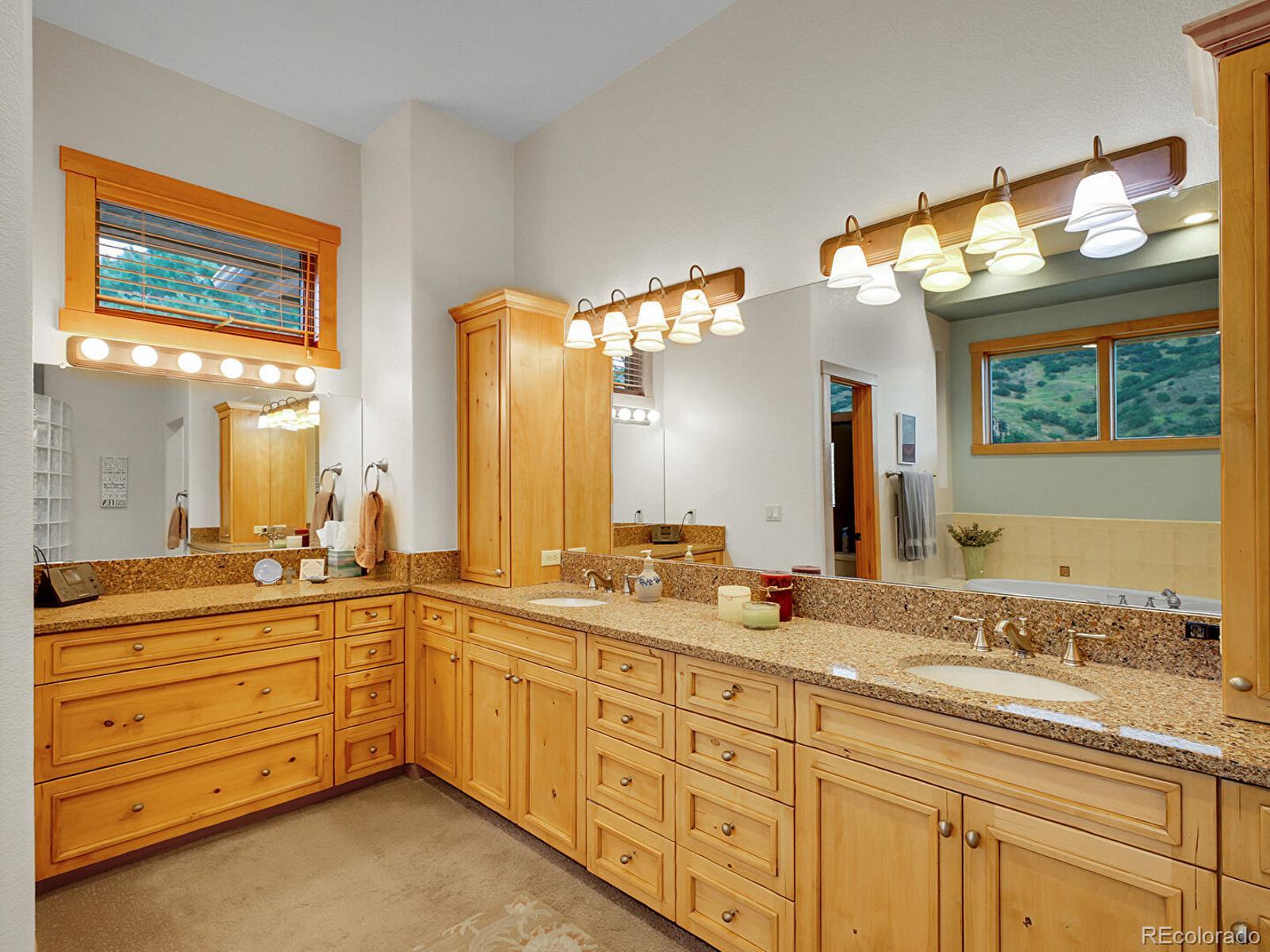 16285 Sandstone Drive Morrison, CO 80465 - Photo 21 of 47 a spacious bathroom with double sink and a mirror
