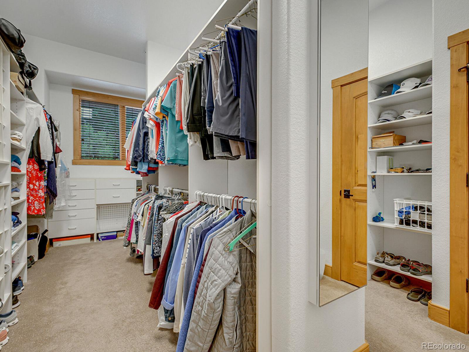 16285 Sandstone Drive Morrison, CO 80465 - Photo 23 of 47 a view of walk in closet with clothes and shoes
