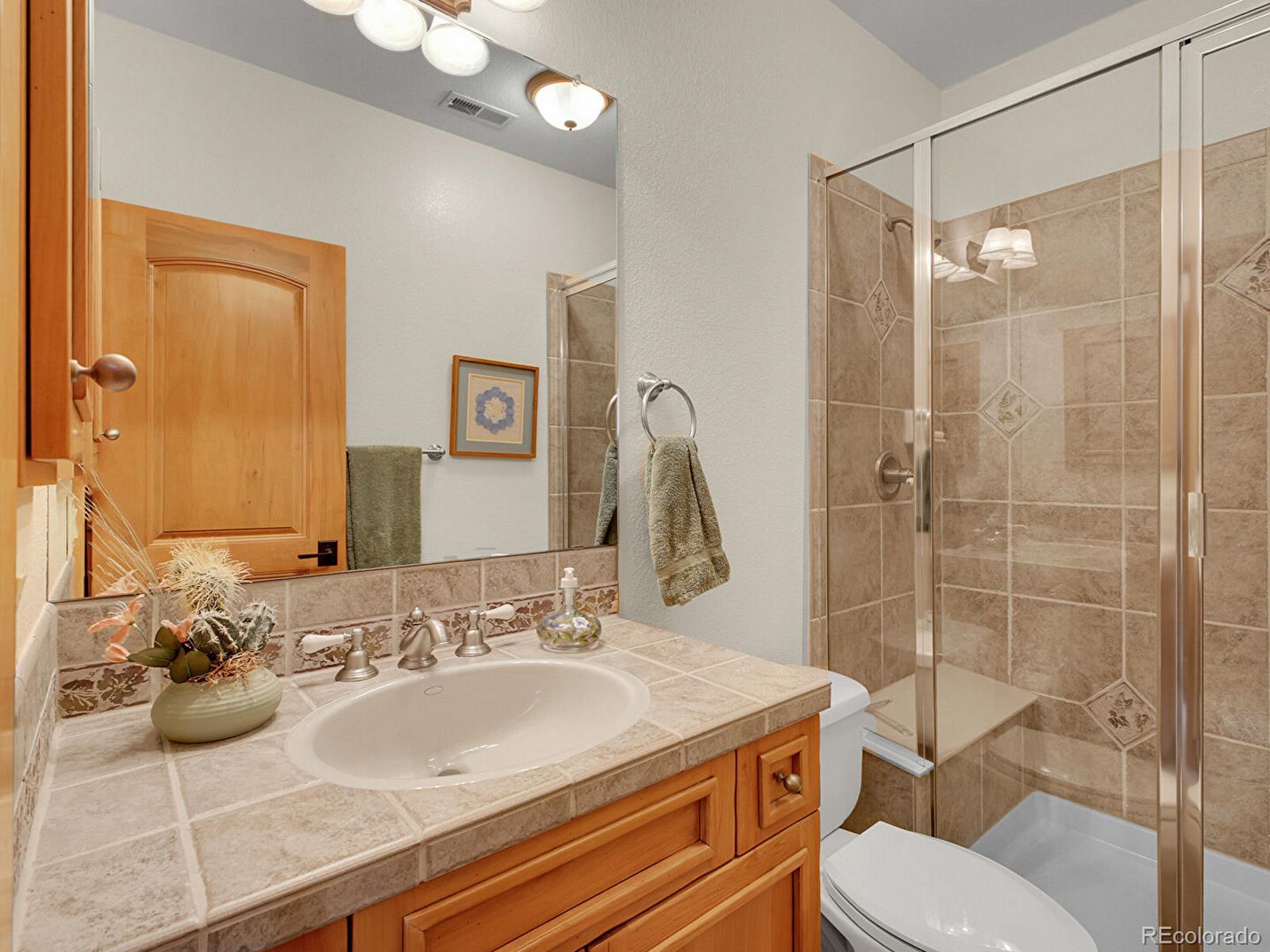 16285 Sandstone Drive Morrison, CO 80465 - Photo 27 of 47 a bathroom with a sink toilet and shower
