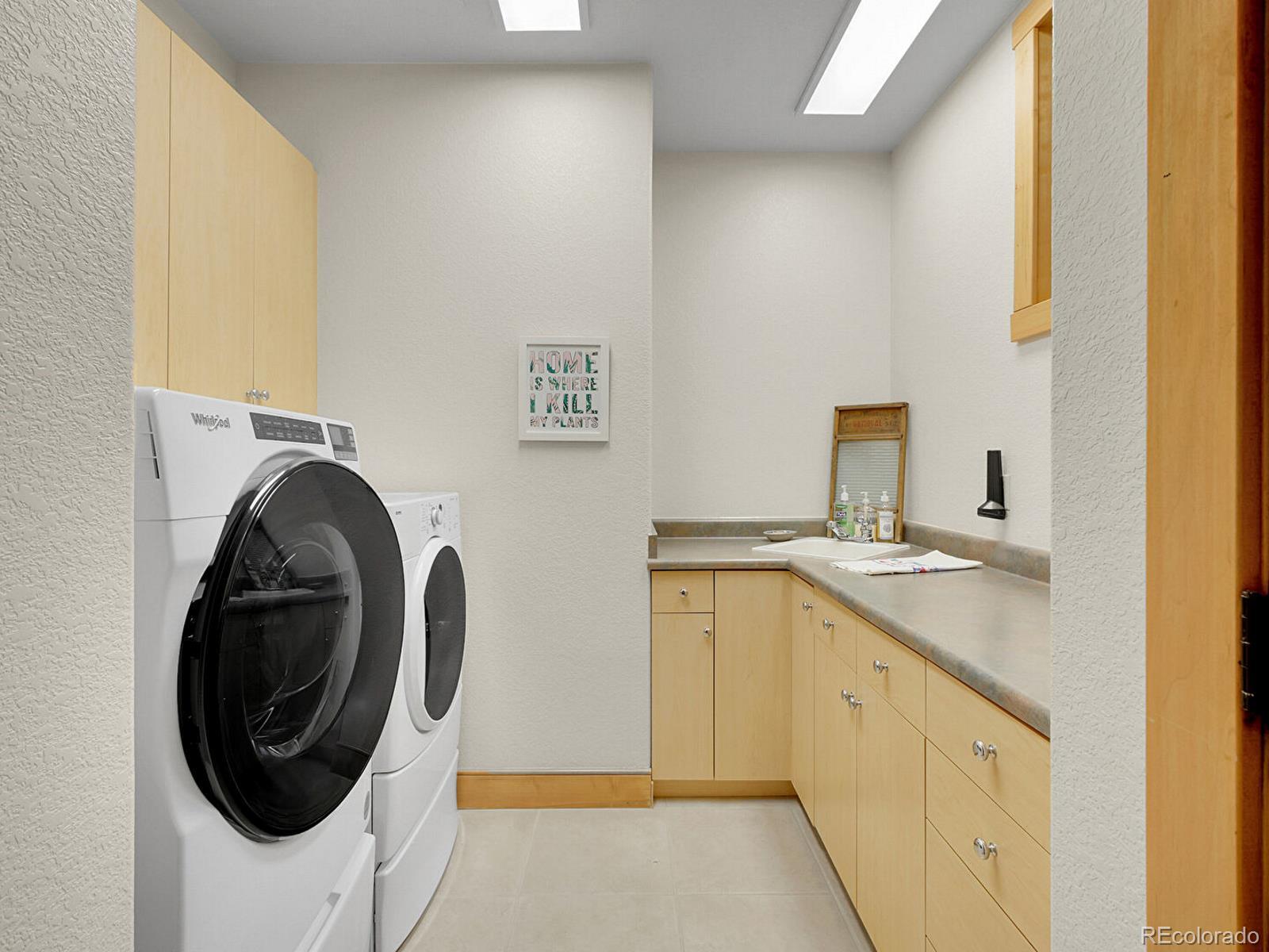 16285 Sandstone Drive Morrison, CO 80465 - Photo 28 of 47 a utility room with sink dryer and washer