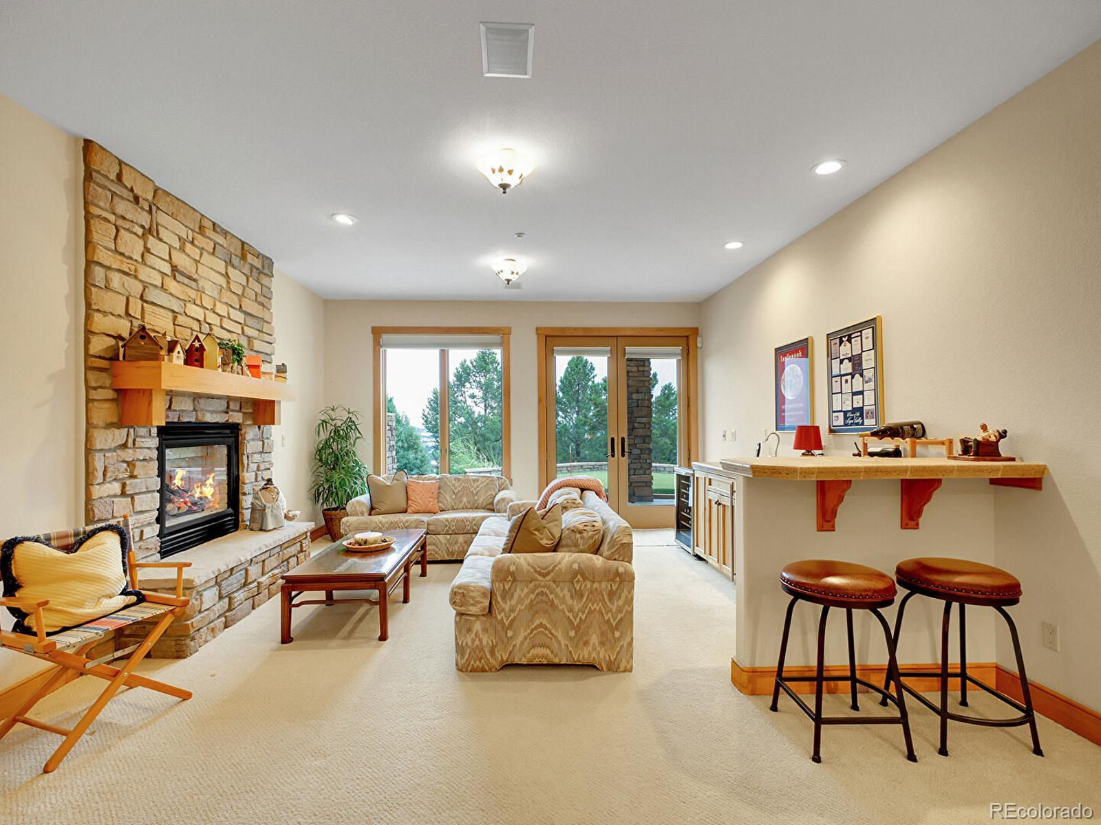 16285 Sandstone Drive Morrison, CO 80465 - Photo 31 of 47 a living room with furniture and a fireplace