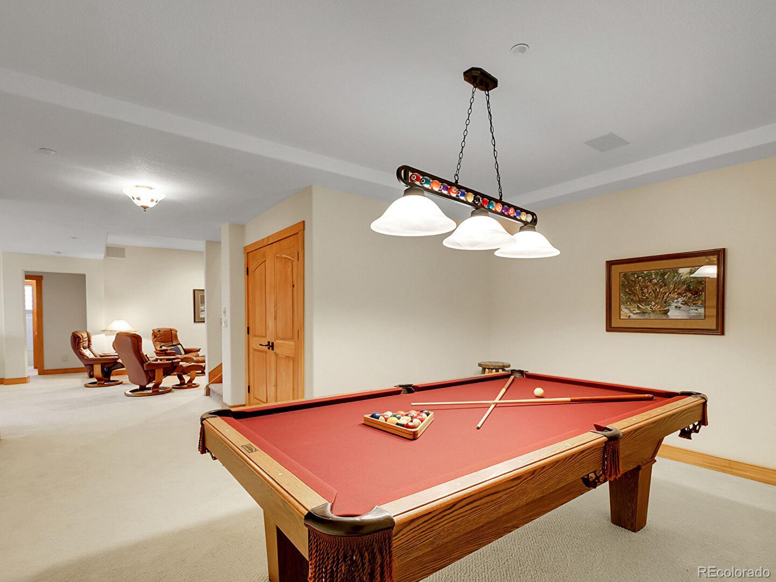 16285 Sandstone Drive Morrison, CO 80465 - Photo 33 of 47 a room with table chairs and a chandelier