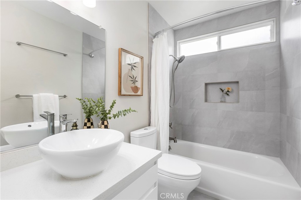 249 Mountain Court Brea, CA 92821 - Photo 23 of 37 a bathroom with a white toilet sitting next to a bathroom sink and a bathtub