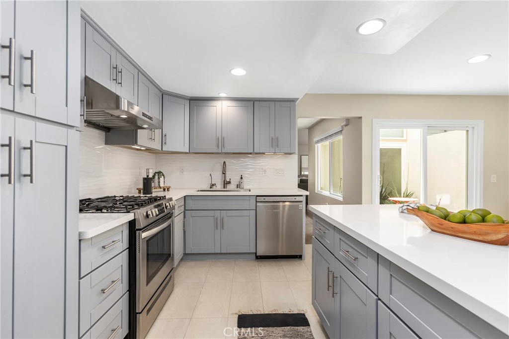 249 Mountain Court Brea, CA 92821 - Photo 9 of 37 a kitchen with stainless steel appliances granite countertop a sink stove and refrigerator