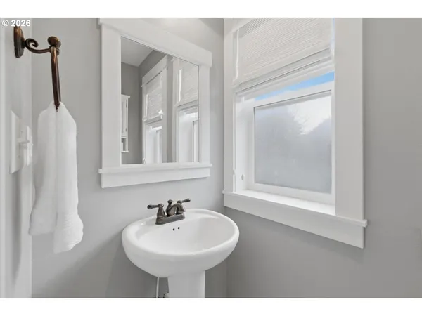 a bathroom with a sink a mirror and a window