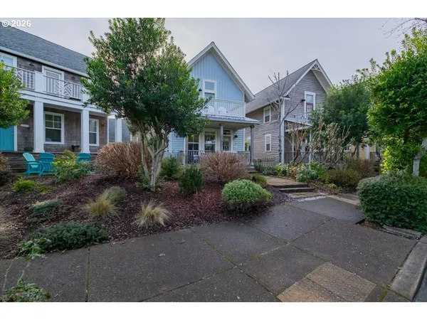 a view of a front of house with a yard and potted plants