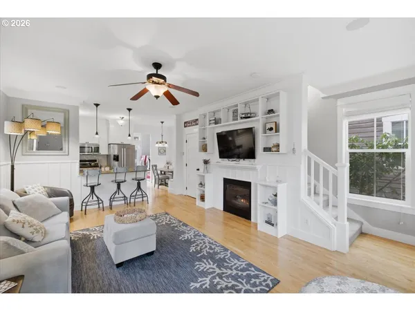 a living room with furniture a fireplace and a flat screen tv