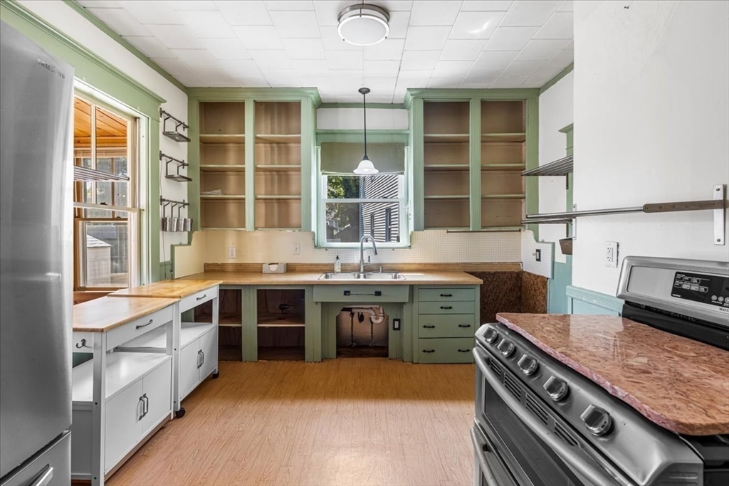 313 Main Street Fairhaven, MA 02719 - Photo 16 of 42 a kitchen with a stove and a sink