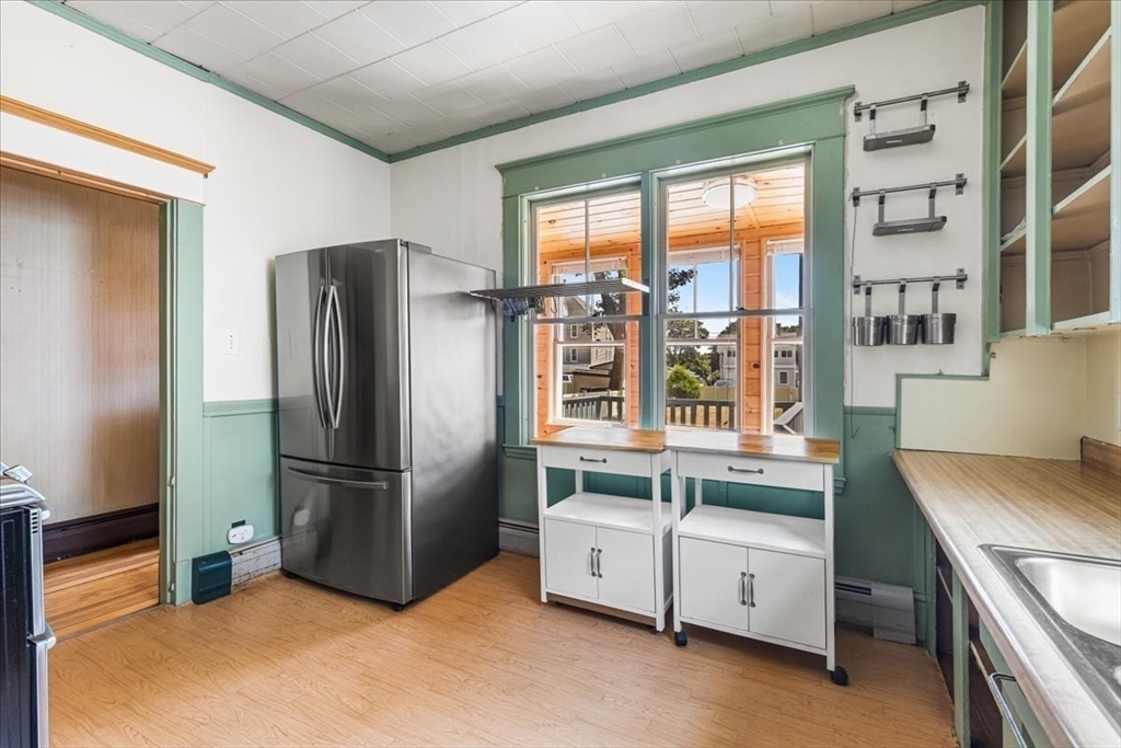 313 Main Street Fairhaven, MA 02719 - Photo 17 of 42 a kitchen with refrigerator a stove and cabinets