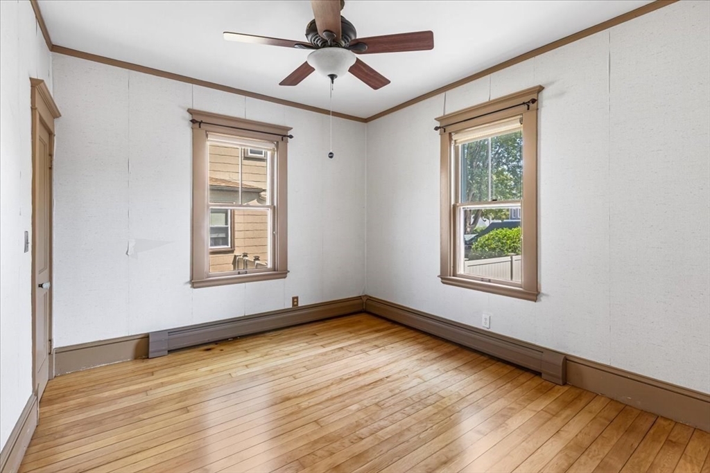 313 Main Street Fairhaven, MA 02719 - Photo 20 of 42 a view of an empty room with wooden floor and a window
