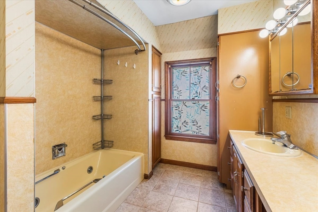 313 Main Street Fairhaven, MA 02719 - Photo 29 of 42 a bathroom with a tub a sink and a shower