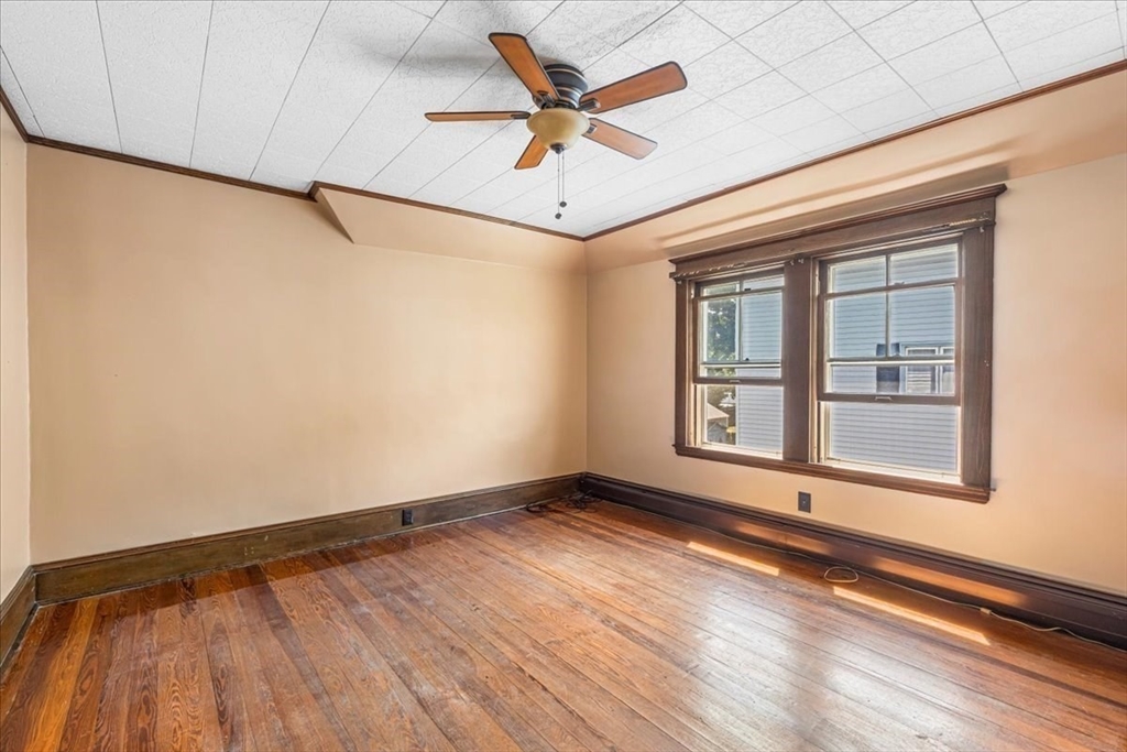 313 Main Street Fairhaven, MA 02719 - Photo 32 of 42 a view of an empty room with a window and wooden floor