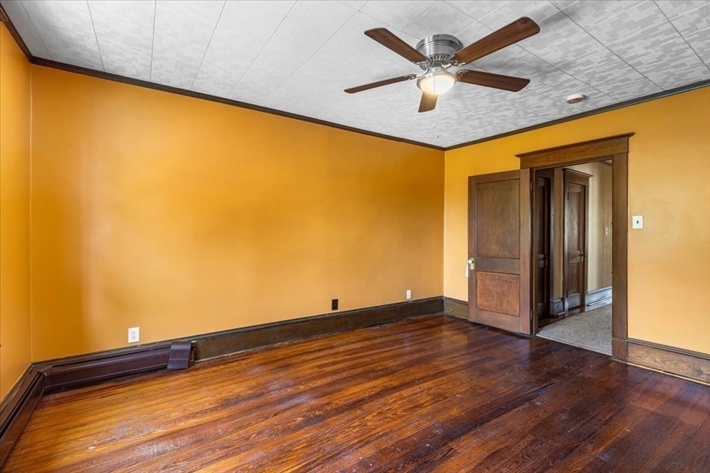 313 Main Street Fairhaven, MA 02719 - Photo 36 of 42 an empty room with wooden floor and a ceiling fan