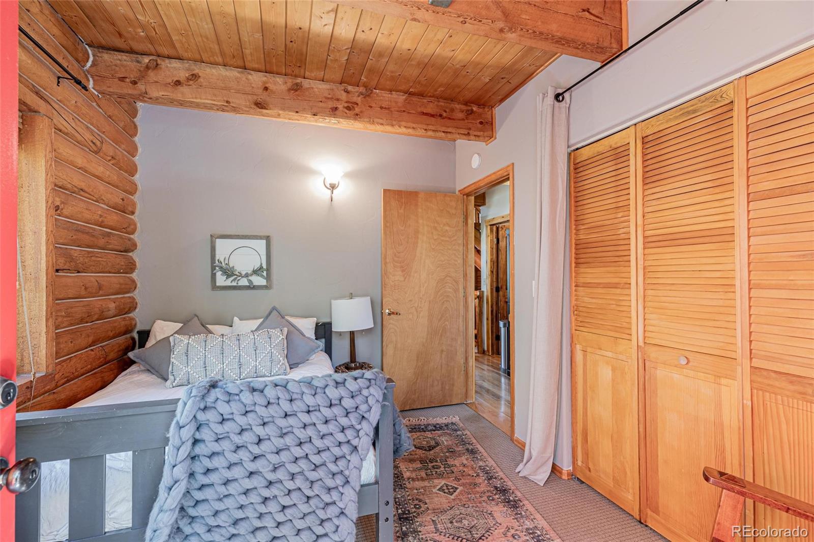 58165 Jupiter Place Clark, CO 80428 - Photo 14 of 34 a bedroom with a bed and wooden floor