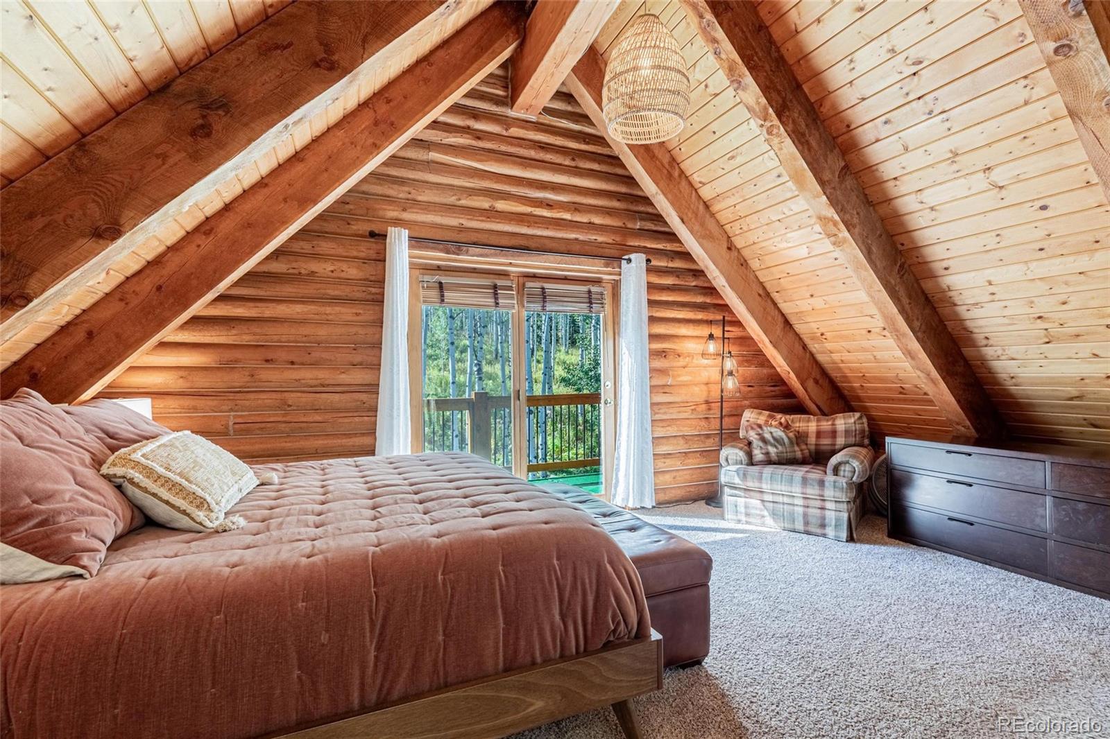 58165 Jupiter Place Clark, CO 80428 - Photo 17 of 34 a bedroom with a bed and large windows