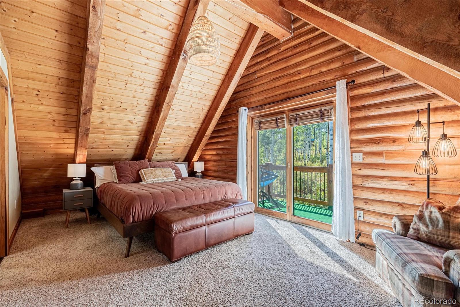 58165 Jupiter Place Clark, CO 80428 - Photo 18 of 34 a bedroom with furniture and large windows