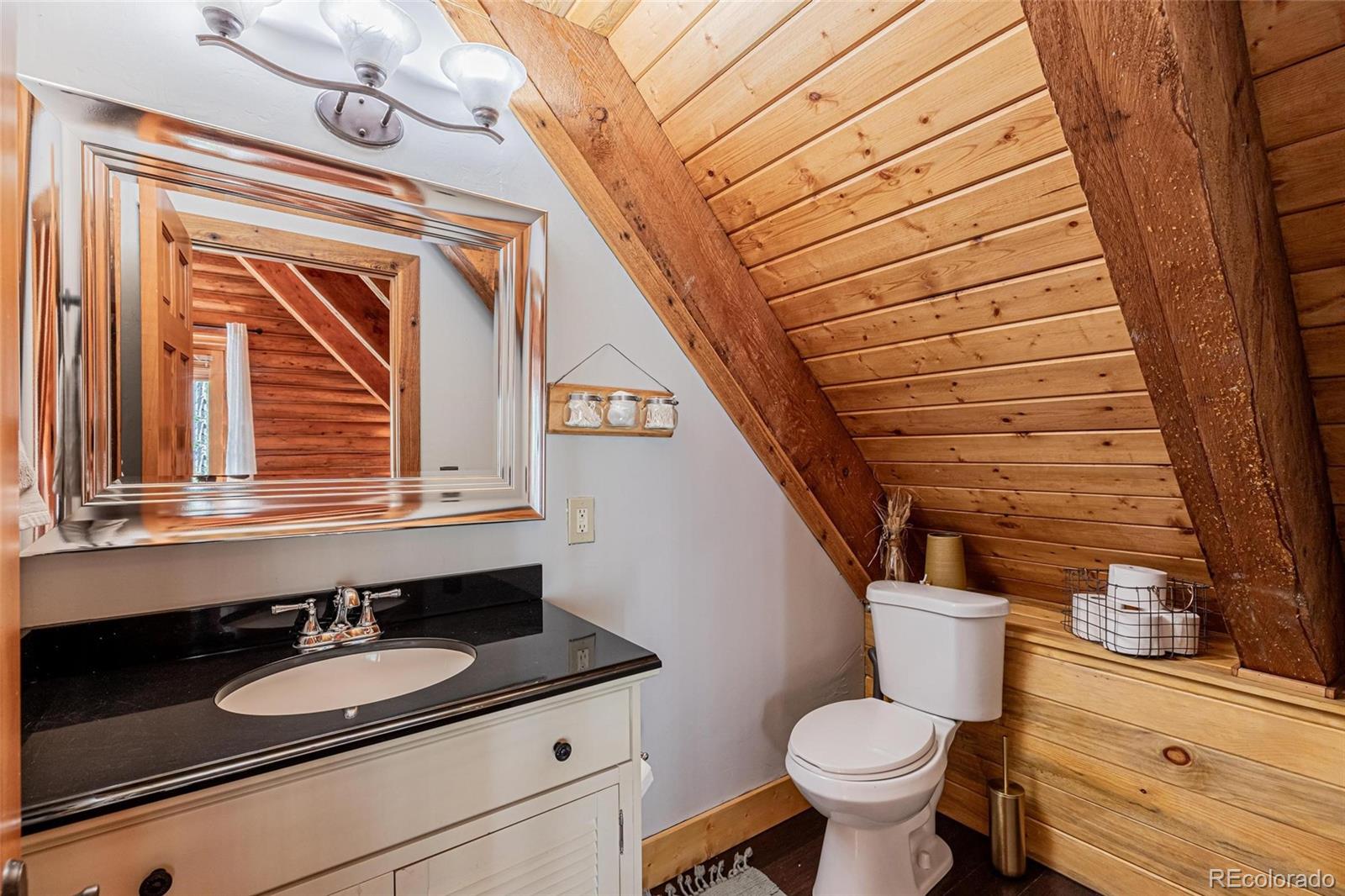 58165 Jupiter Place Clark, CO 80428 - Photo 20 of 34 a bathroom with a granite countertop toilet sink and mirror