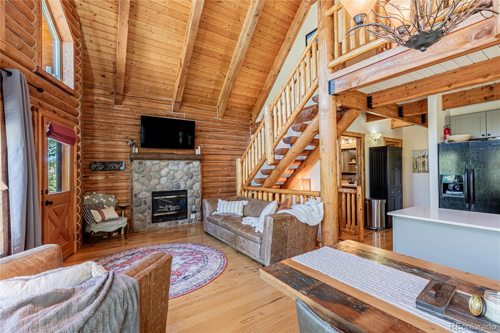 58165 Jupiter Place Clark, CO 80428 - Photo 2 of 34 a living room with furniture and a fireplace