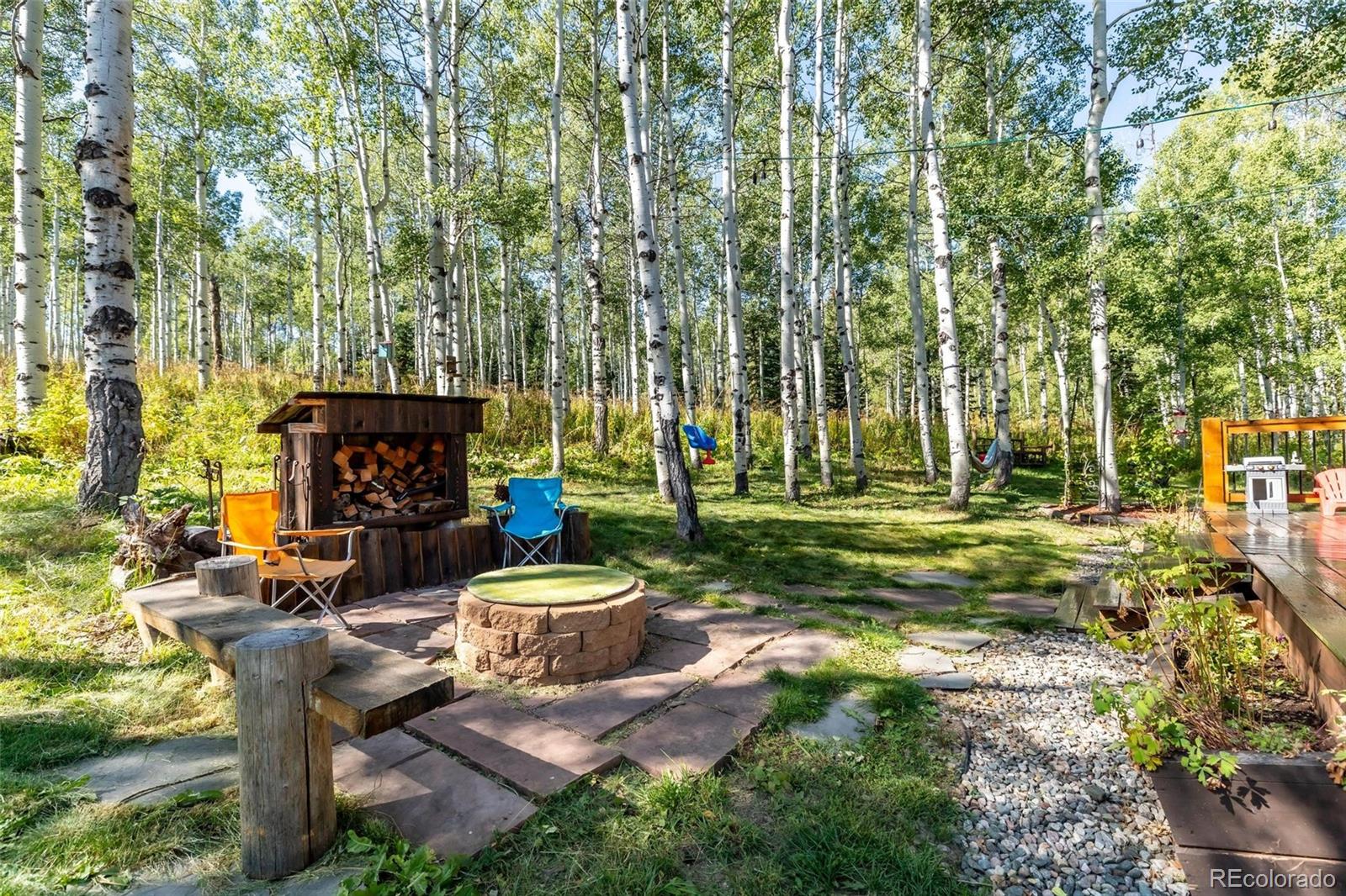 58165 Jupiter Place Clark, CO 80428 - Photo 29 of 34 a view of a chairs and tables in the backyard of the house