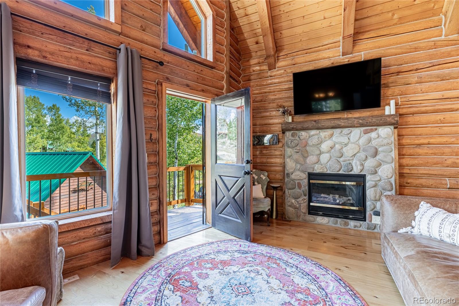 58165 Jupiter Place Clark, CO 80428 - Photo 3 of 34 a living room with furniture a flat screen tv and a fireplace