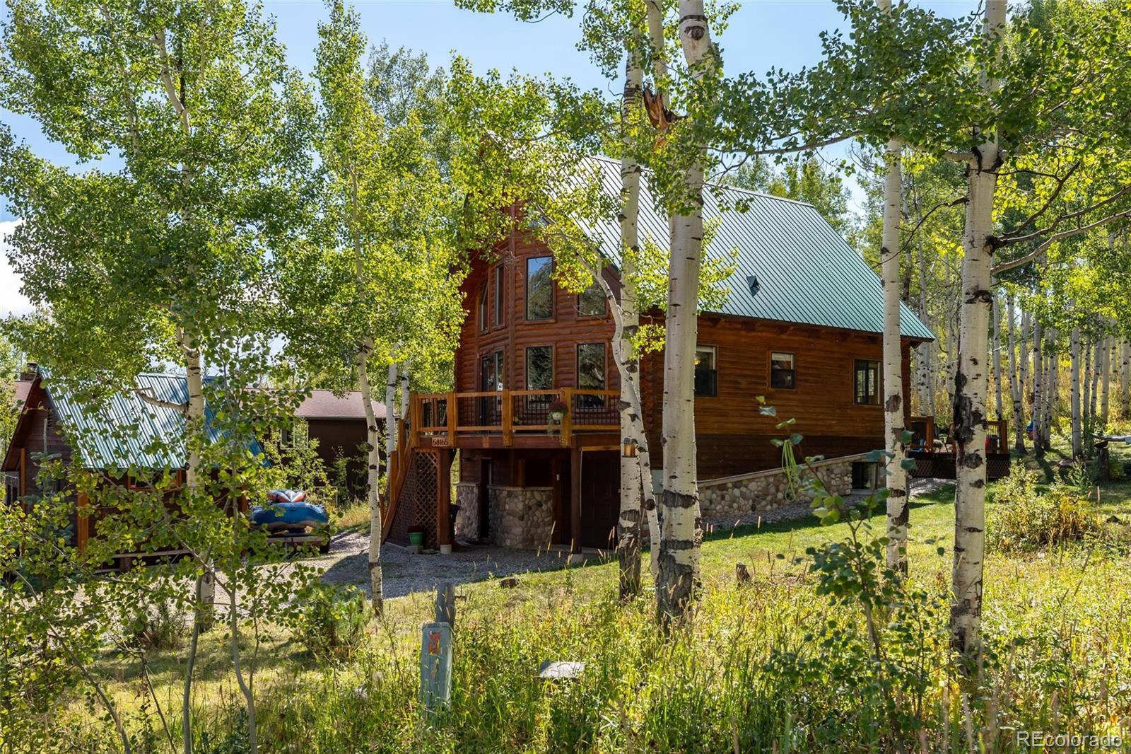 58165 Jupiter Place Clark, CO 80428 - Photo 31 of 34 a view of a house with a yard