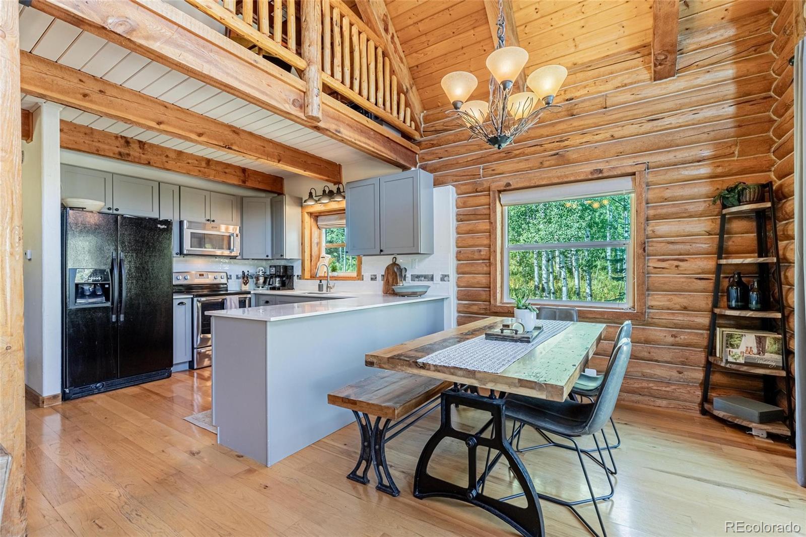 58165 Jupiter Place Clark, CO 80428 - Photo 9 of 34 a dining room with a wooden table and chairs