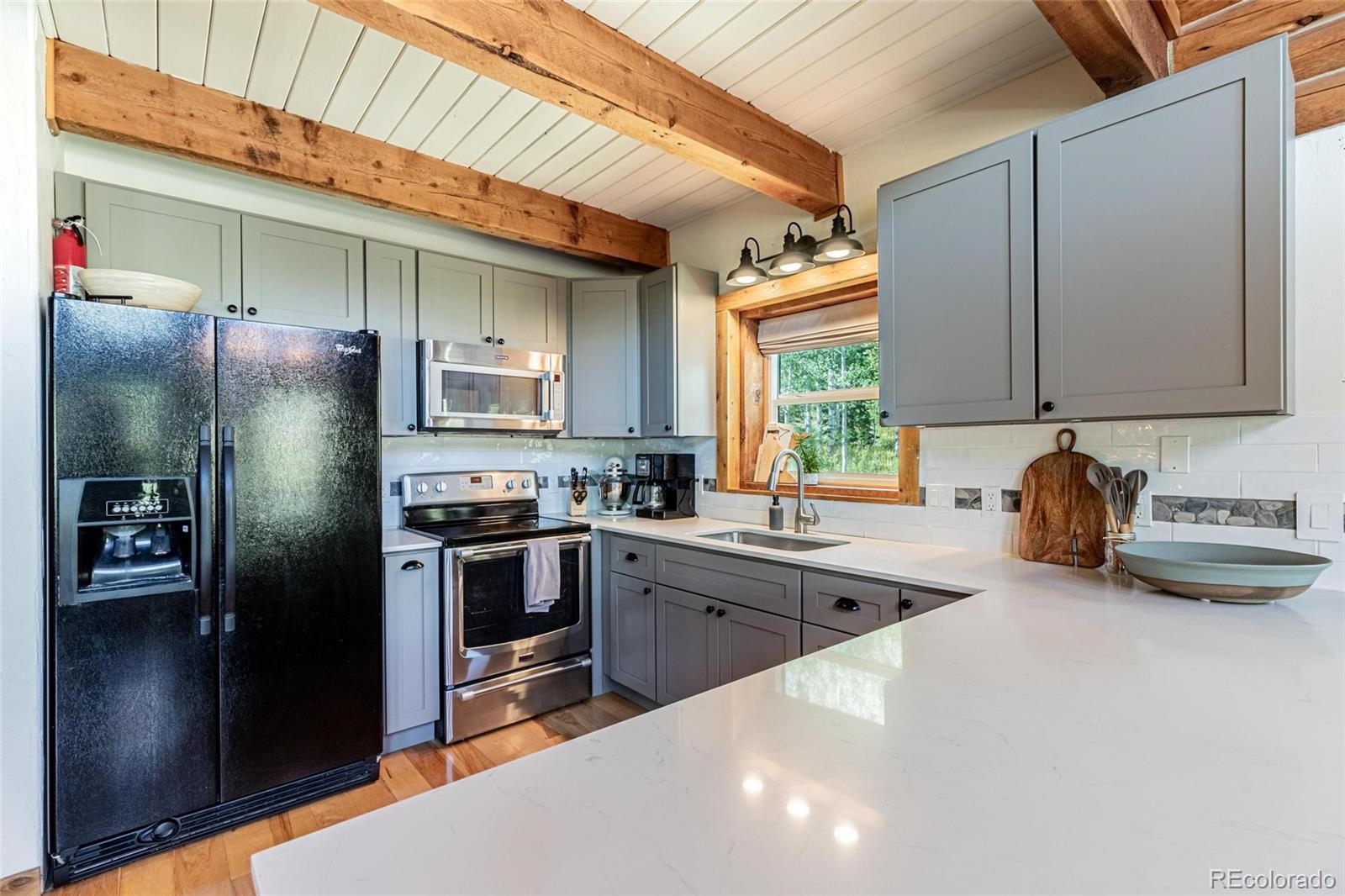 58165 Jupiter Place Clark, CO 80428 - Photo 10 of 34 a kitchen with stainless steel appliances granite countertop a sink a stove and refrigerator