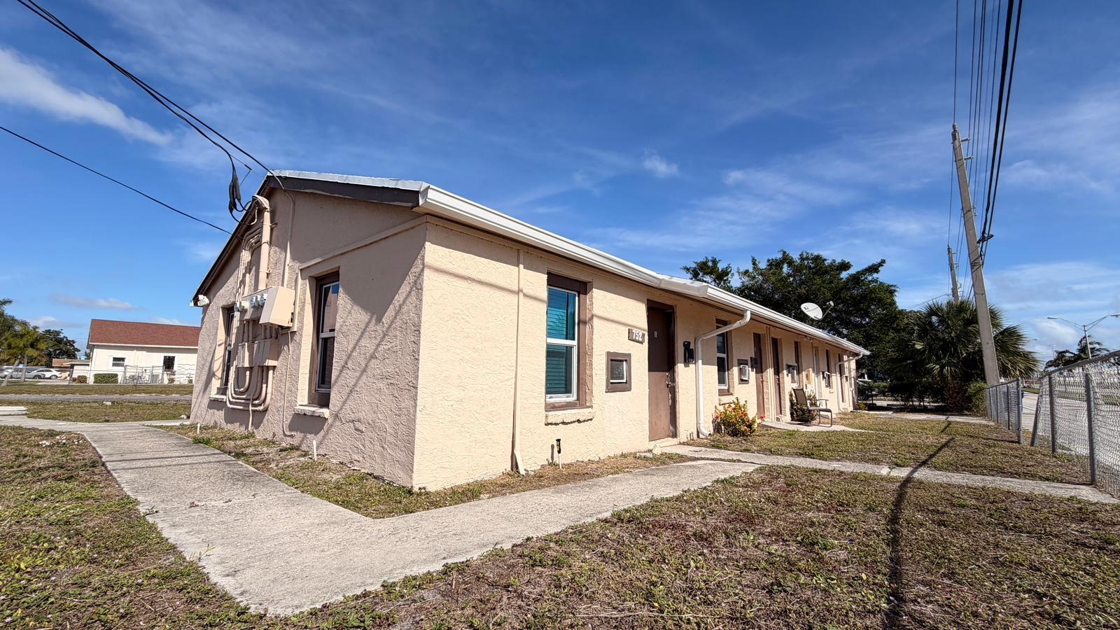 752 Martin Luther King Jr Boulevard, Unit 15 Riviera Beach, FL 33404 - Photo 3 of 14 a front view of a house with a yard