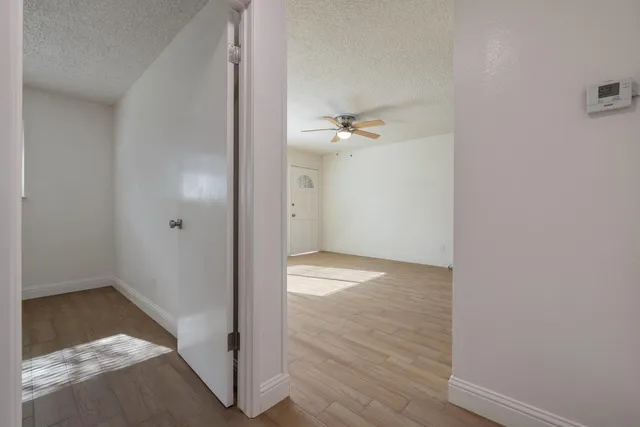 a view of a room with wooden floor