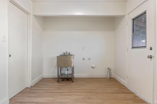 a view of empty room with wooden floor