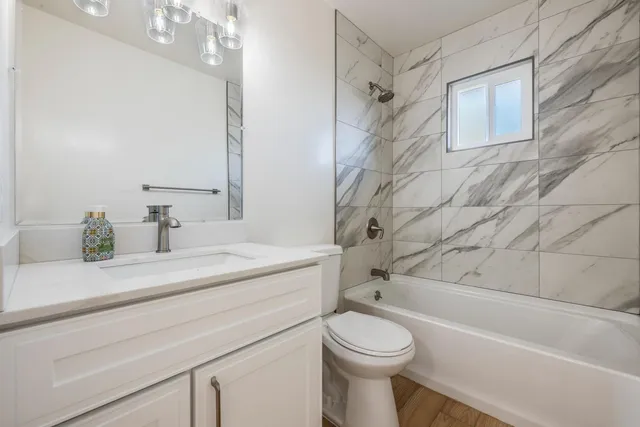 a bathroom with a sink a toilet and bathtub