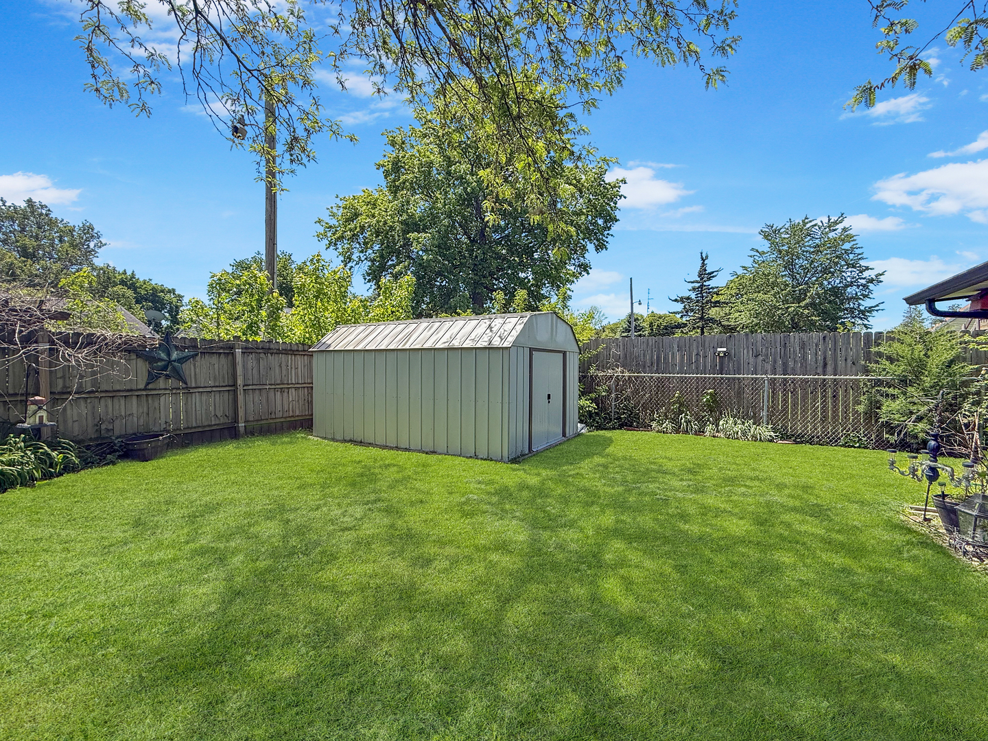 814 Pinecrest Drive Rantoul, IL 61866 - Photo 21 of 22 a view of a backyard with a garden and trees