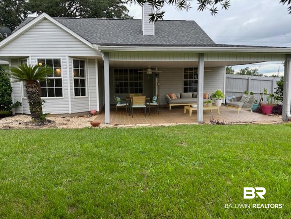 1512 North Cedar Street Foley, AL 36535 - Photo 13 of 13 Rear view of house with a lawn and an outdoor living space