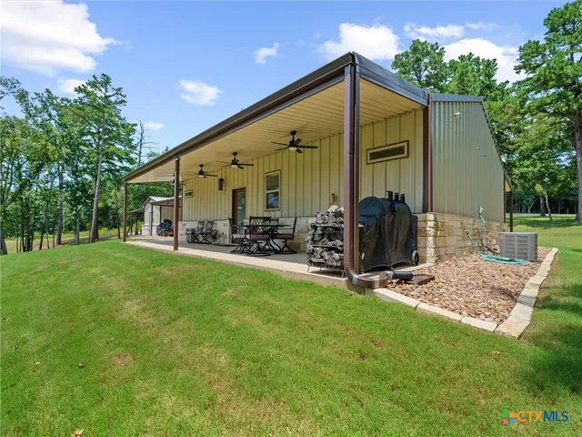 a view of a house with backyard and balcony