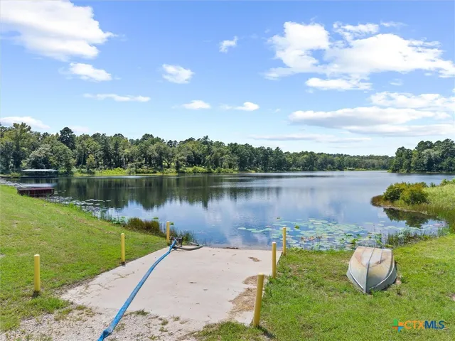 a view of a swimming pool with a bench and trees